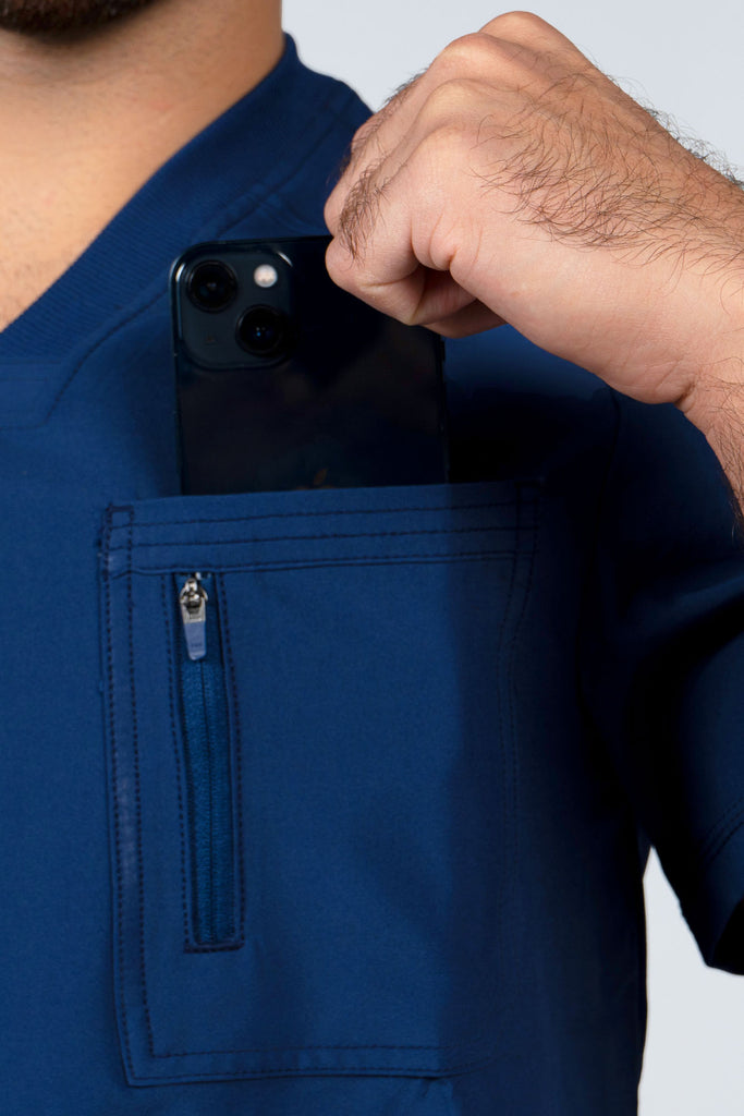 Men's Performance Zip Scrub Top in Navy closeup on model putting phone into pocket