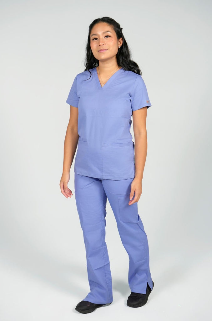 Women's 6-Pocket Elastic Scrub Pant in Periwinkle front view on model wearing matching periwinkle scrub top