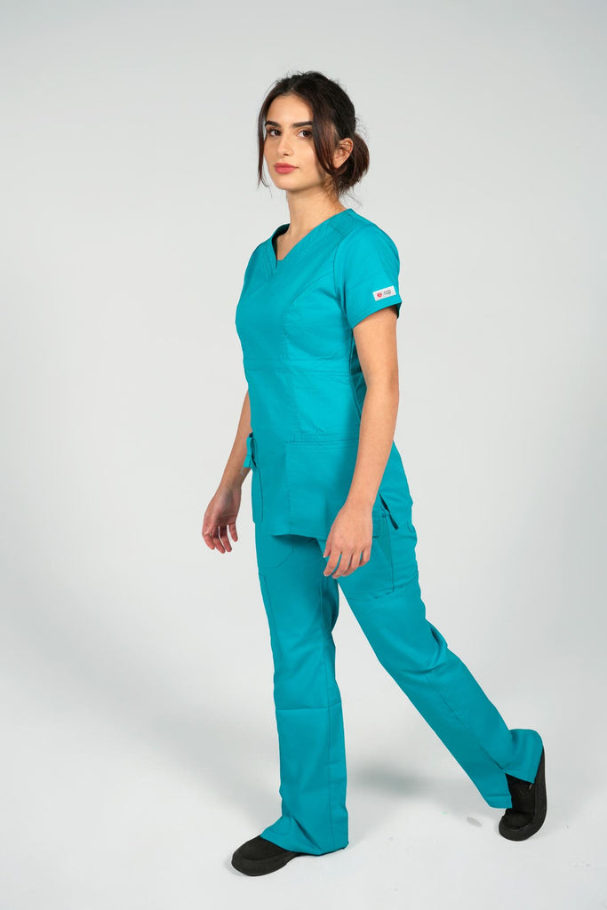 Women's 4-Pocket Curved V-Neck Scrub Top in Teal sideview on model wearing matching teal scrub bottoms