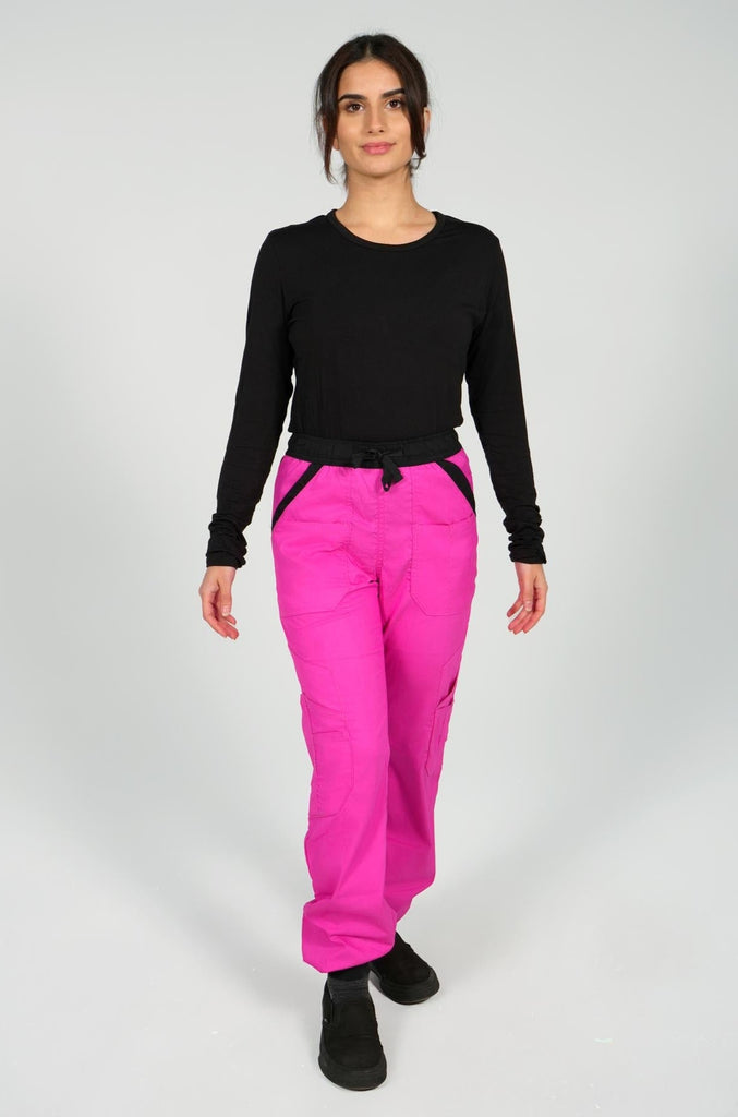 woman modeling pink cargo scrub joggers from rhino workwear with black underscrub top