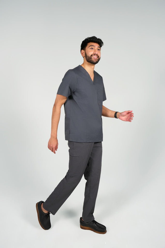 Men's 2-Pocket V-Neck Scrub Top in Charcoal sideview on model wearing matching scrub pants in charcoal