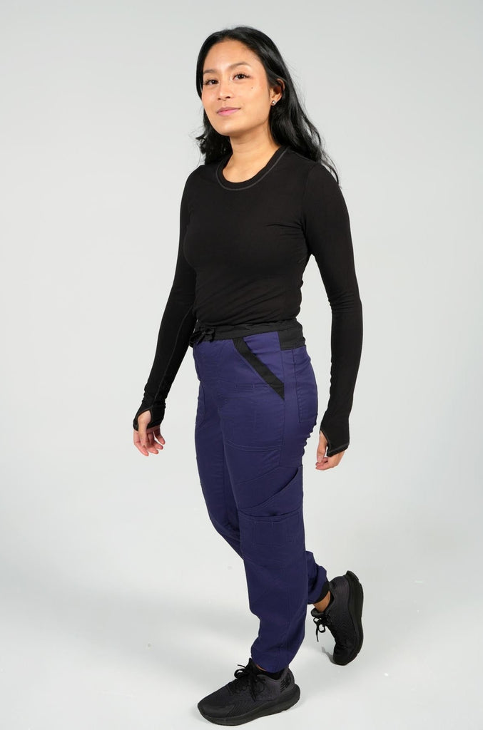 Women's 14-Pocket Cargo Scrub Jogger in shade navy side view with matching black underscrub top