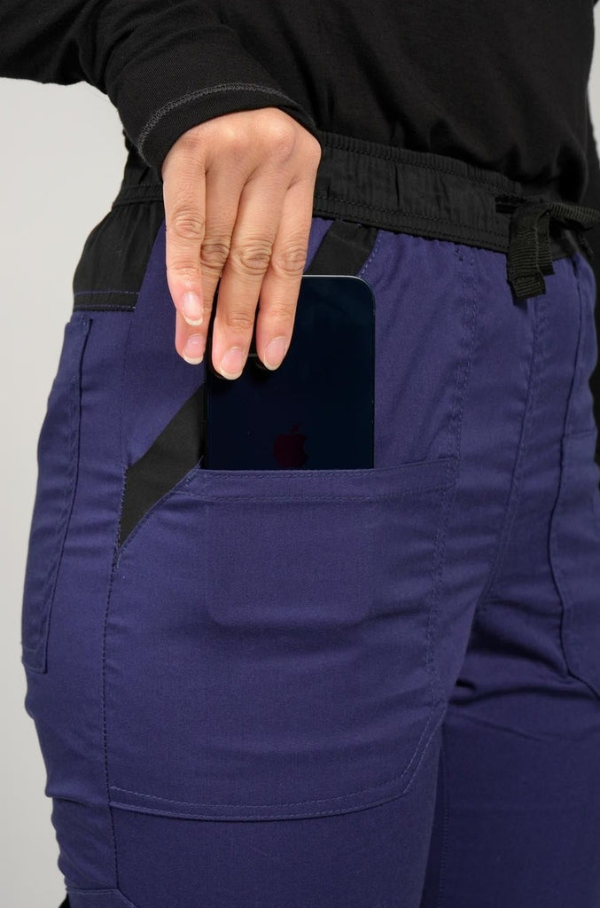 Women's 14-Pocket Cargo Scrub Jogger in shade navy close up view of phone in pocket