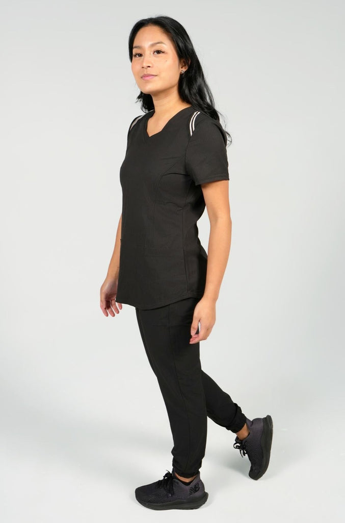 Women's Active Striped Scrub Top in black on model worn with black scrub pants