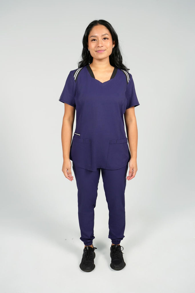 Women's Active Striped Scrub Top in navy worn by model with navy scrub jogger pants