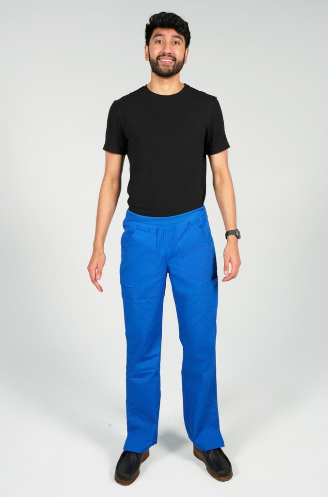 Men's 6-Pocket Elastic Scrub Pant in Royal Blue front view on model wearing black top