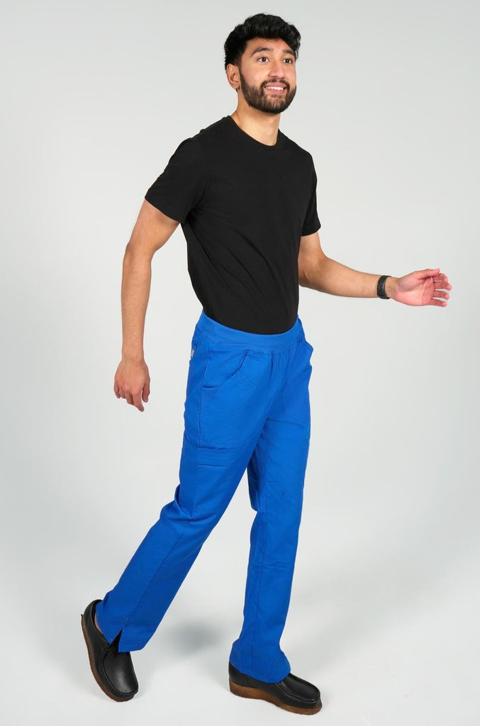 Men's 6-Pocket Elastic Scrub Pant in Royal Blue side view on model wearing black top