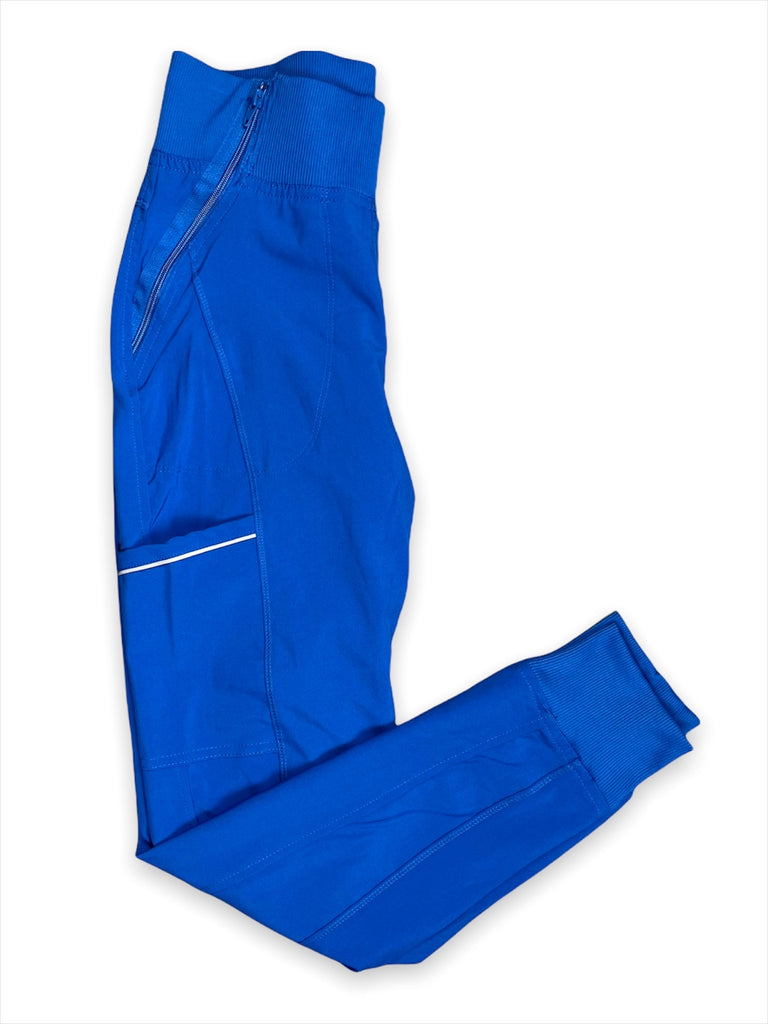 Women's Performance Scrub Jogger in shade royal blue folded view, showing elastic waistband, zip, pocket and ankle cuff
