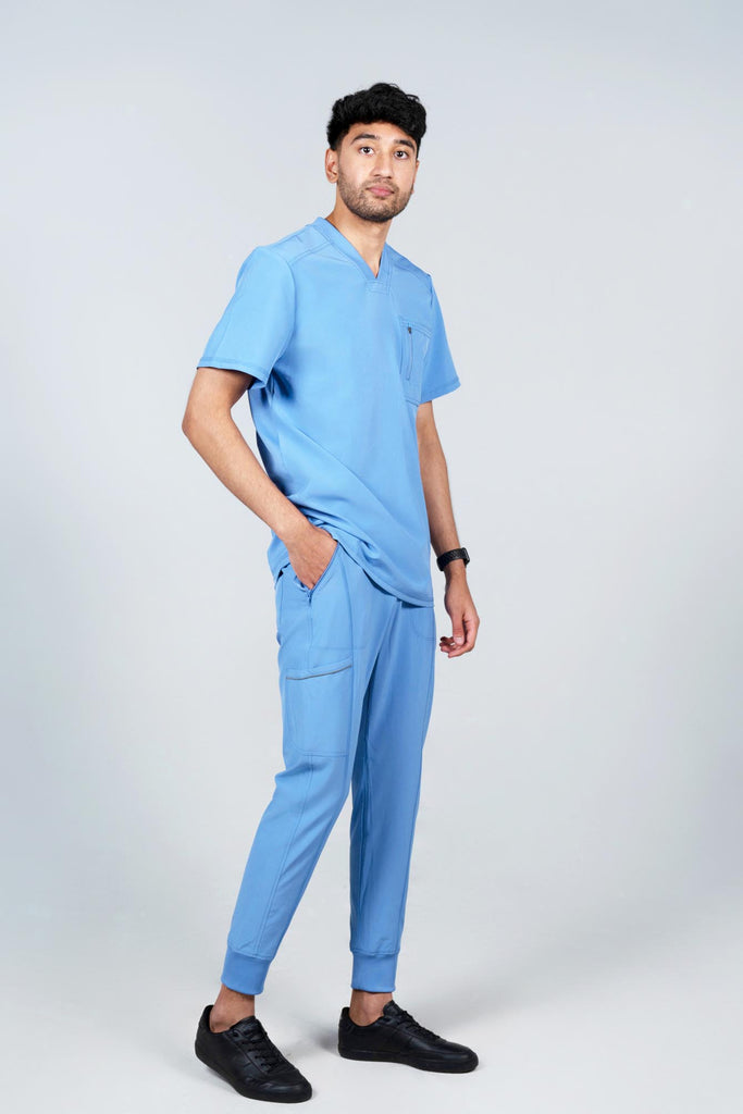 Men's Performance Scrub Jogger in shade periwinkle worn by model with periwinkle matching scrub top side view