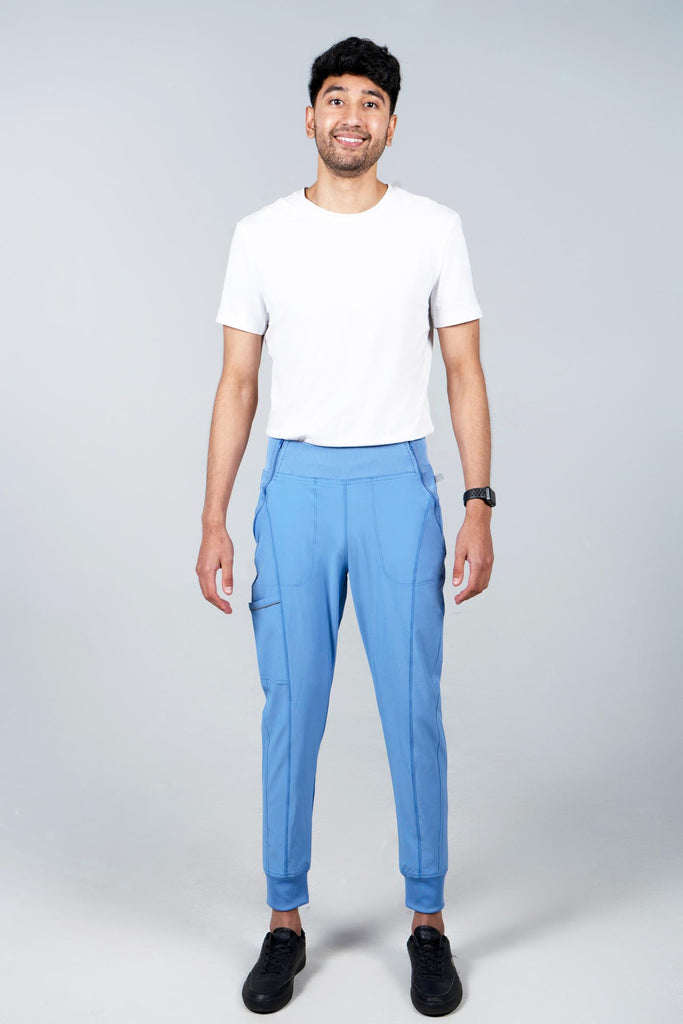 Men's Performance Scrub Jogger in shade periwinkle worn by model with white top front view