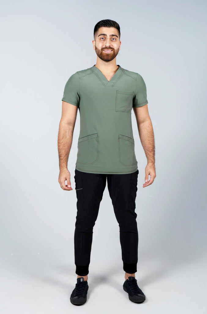 Men's Performance Scrub Top in Olive front view on model wearing black performance jogger scrub pants