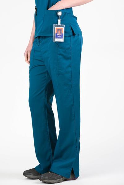 Women’s premium Flex Scrub Pants in shade caribbean shown from side paired with matching caribbean flex scrub top. Attached id badge hanging from utility loop