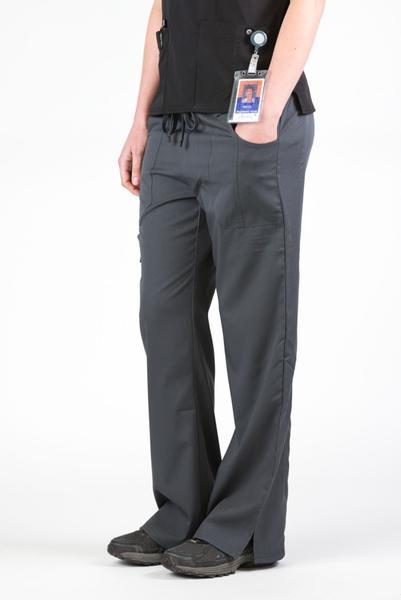 Women’s premium Flex Scrub Pants in shade pewter shown from side. Attached id badge hanging from utility loop on black scrub top paired with pants.
