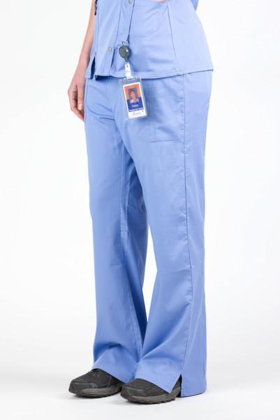 Women’s premium Flex Scrub Pants in shade periwinkle shown from side. Attached id badge hanging from utility loop