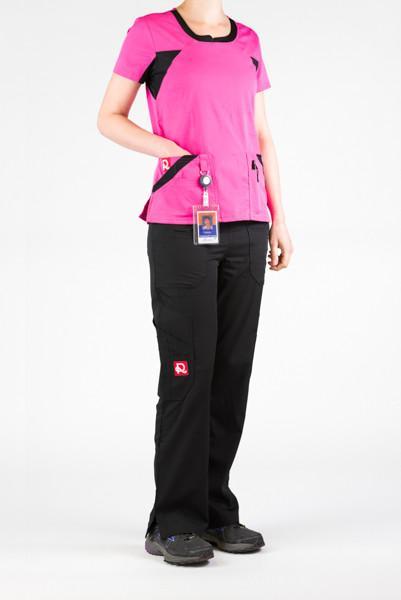 Women's Ultra Flex 4-pocket Scrub Top in pink on model wearing black flex scrub pants side view with id badge hanging from utility loop