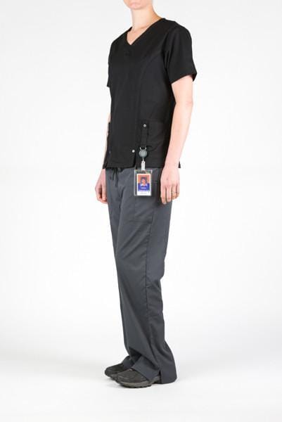 Women’s premium Flex 3-Pocket Scrub Top in shade black paired with women's Flex Pants in shade pewter sideview with id badge hanging from utility loop