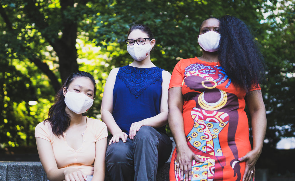 Reusable Cloth Mask With Built in Filter in white worn by three female models