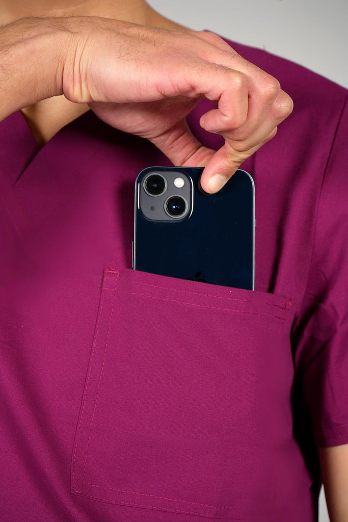 Men's 3-Pocket Scrub Top in Wine closeup on model putting phone into pocket