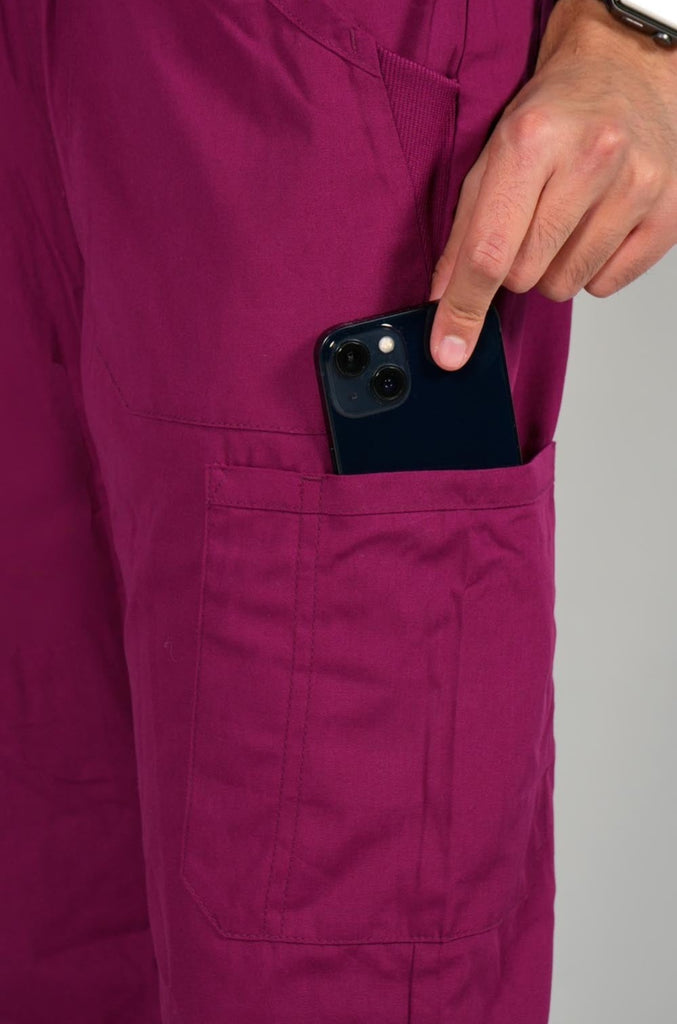 Men's 6-Pocket Elastic Scrub Pant in Wine closeup on model putting phone into pocket