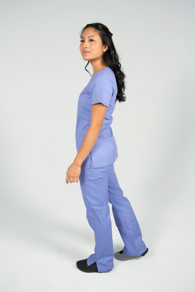 Women's Tailored 4-Pocket V-Neck Scrub Top in Periwinkle sideview on model wearing matching periwinkle scrub pants