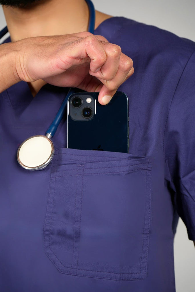 Men's 2-Pocket V-Neck Scrub Top in Navy model taking phone out of pocket