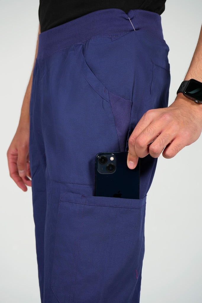 Men's 6-Pocket Elastic Scrub Pant in Navy closeup on model putting phone into pocket