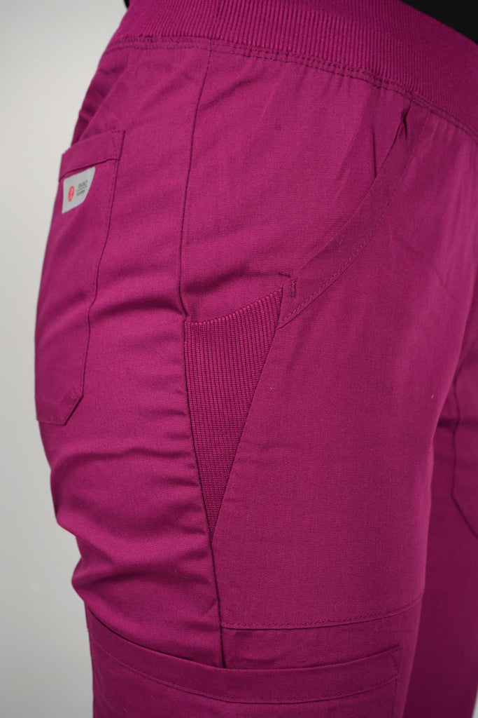 Women's 6-Pocket Elastic Scrub Pant in Wine closeup on pocket with elastic stretch panel