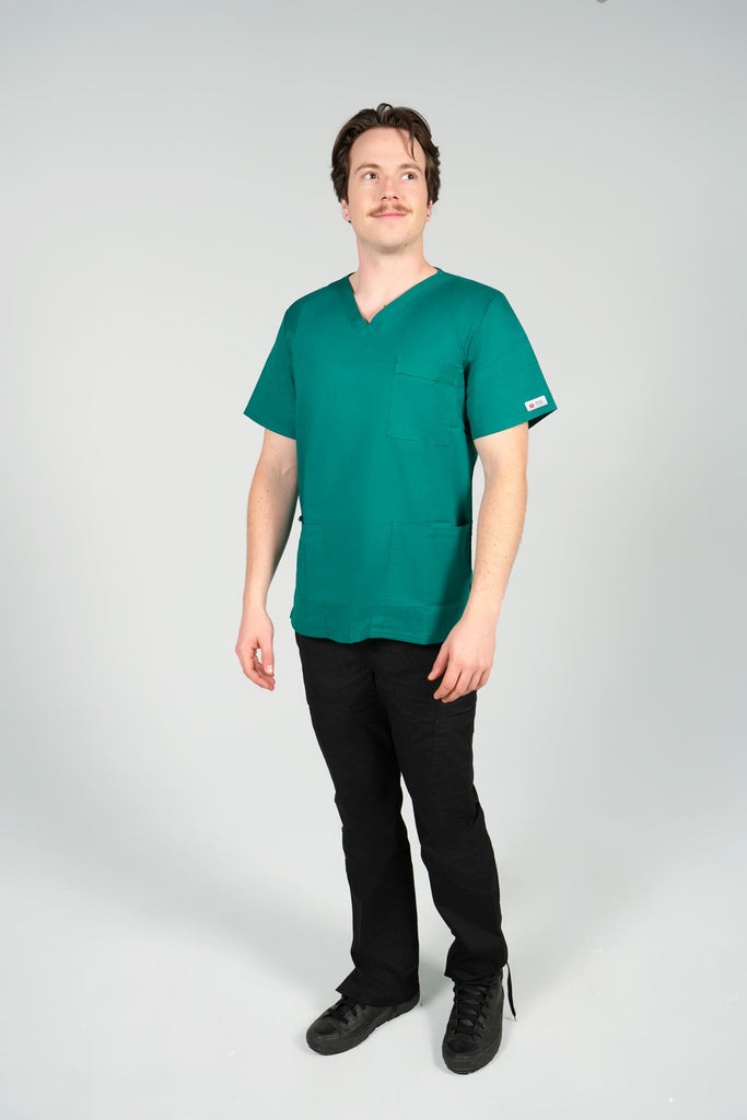 Men's 4-Pocket Scrub Top in Forest Green front view on model wearing black scrub pants