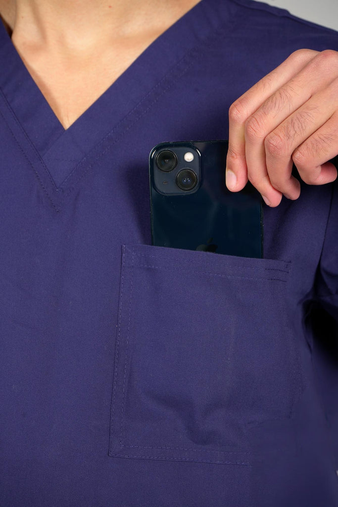 Men's 3-Pocket Scrub Top in Navy closeup on model putting phone into pocket