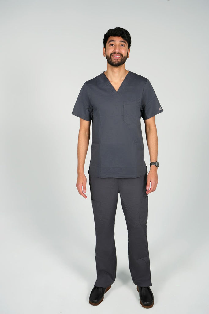 Men's 2-Pocket V-Neck Scrub Top in Charcoal front view on model wearing matching charcoal scrub pants