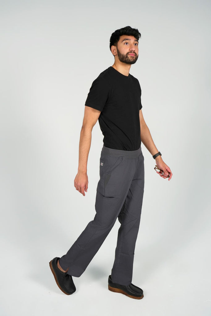 Men's 6-Pocket Elastic Scrub Pant in Charcoal side view on model wearing black top