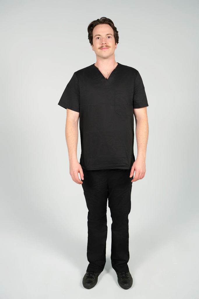 Men's 2-Pocket V-Neck Scrub Top in Black front view on model wearing matching black scrub pants