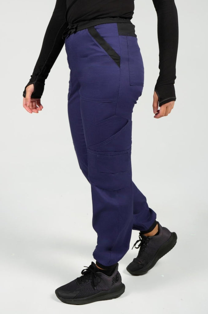 Women's 14-Pocket Cargo Scrub Jogger in shade navy side view with model walking