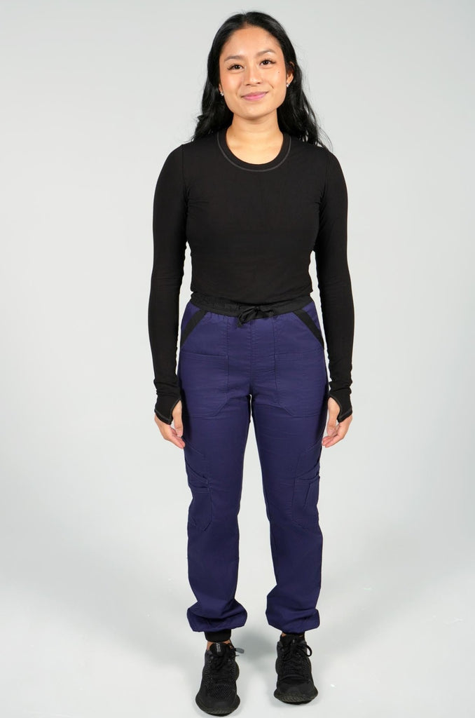 Women's 14-Pocket Cargo Scrub Jogger in shade navy front view with matching black underscrub top