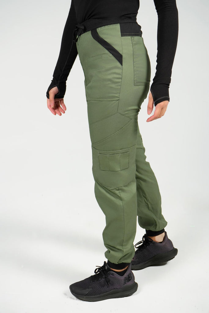 Women's 14-Pocket Cargo Scrub Jogger in shade olive side view with model walking