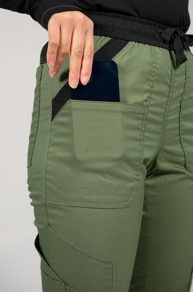 Women's 14-Pocket Cargo Scrub Jogger in shade olive close up view of phone in pocket