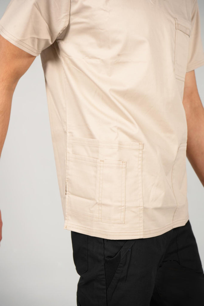Men's 4-Pocket Scrub Top in beige on model closeup on pockets