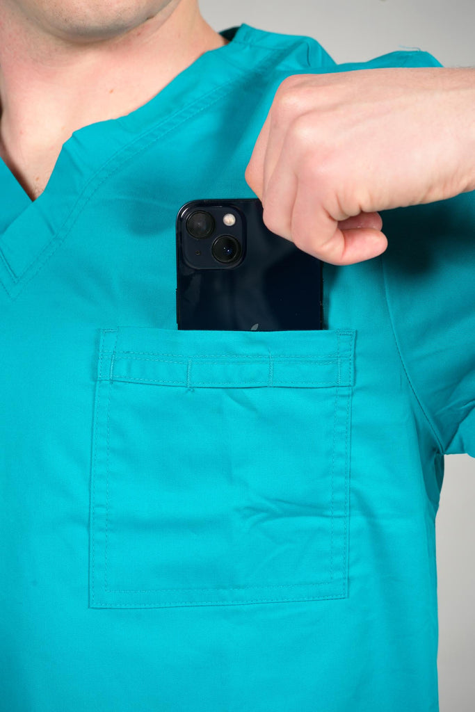 Men's 4-Pocket Scrub Top in Teal model putting phone into top pocket