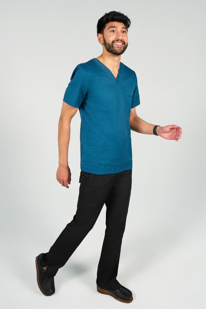 Men's 4-Pocket Scrub Top in Caribbean side view on model wearing black scrub pants