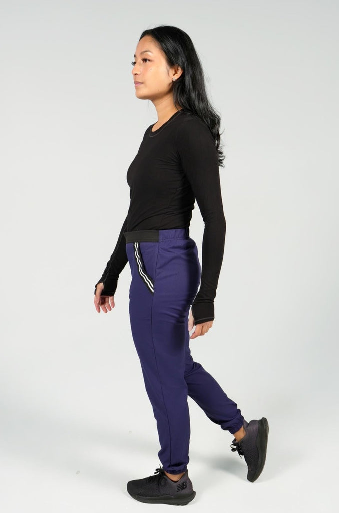 Women's Active Striped Scrub Jogger in navy side view on model with black underscrub top