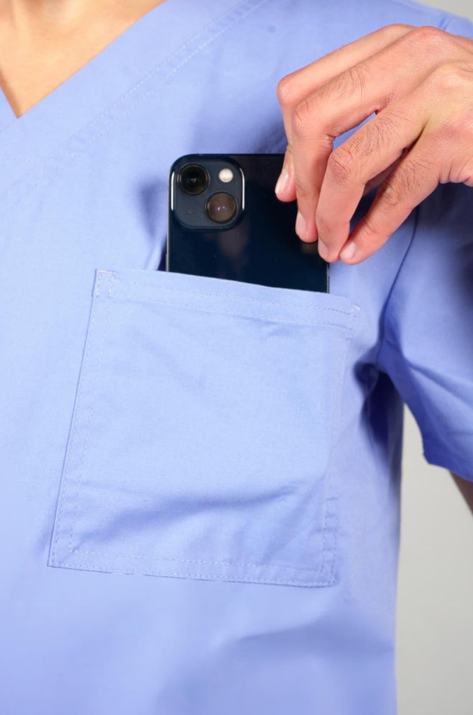 Men's 3-Pocket Scrub Top in Periwinkle closeup on model putting phone into pocket