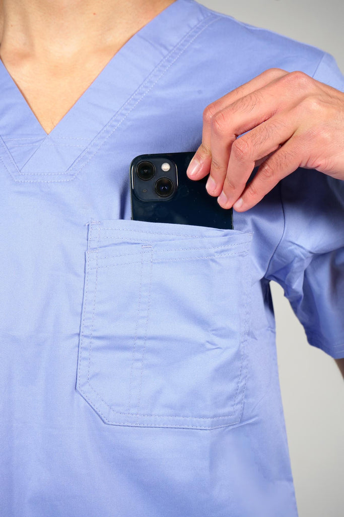 Men's 2-Pocket V-Neck Scrub Top in Periwinkle model putting phone into pocket
