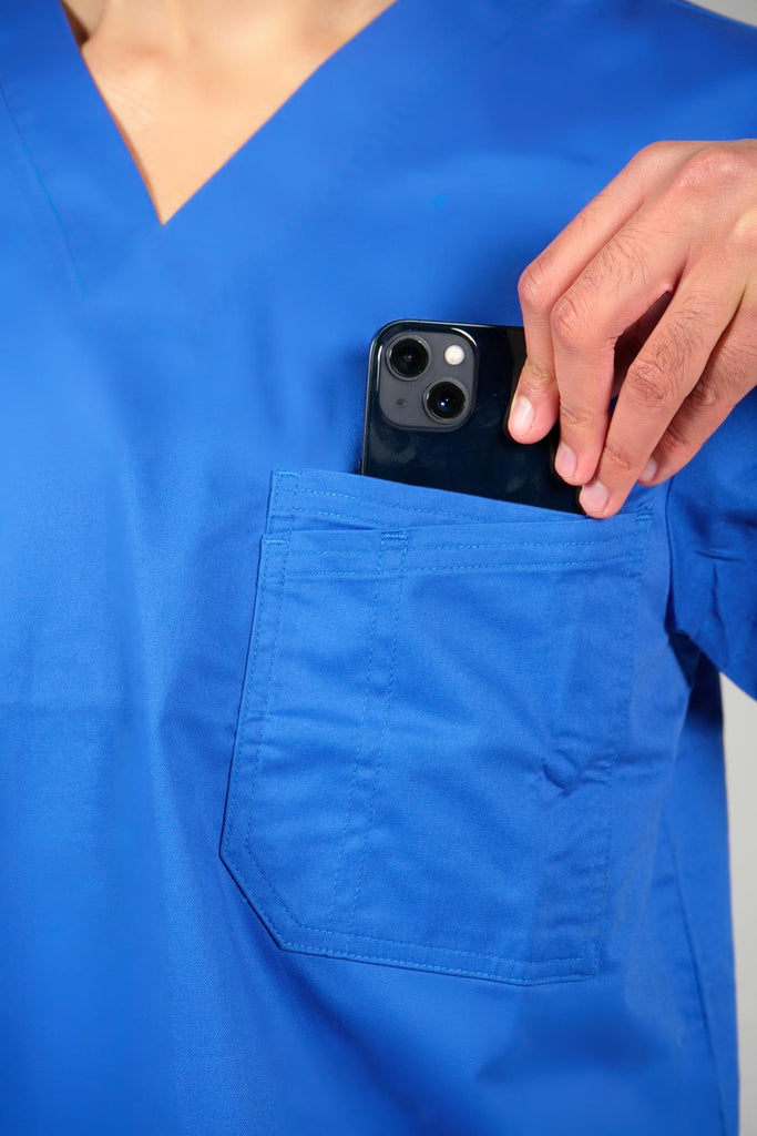 Men's 2-Pocket V-Neck Scrub Top in Royal Blue model pulling phone out of top pocket