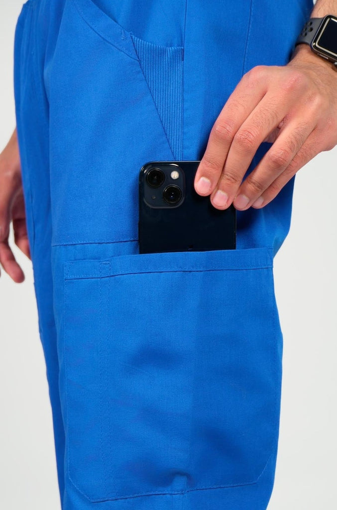 Men's 6-Pocket Elastic Scrub Pant in Royal Blue closeup on model putting phone into pocket