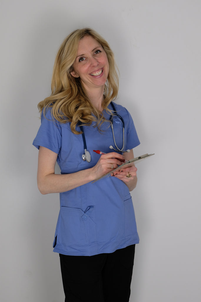 Women's 4-Pocket Curved V-Neck Scrub Top in Periwinkle front view on model with stethoscope and clipboard in hand