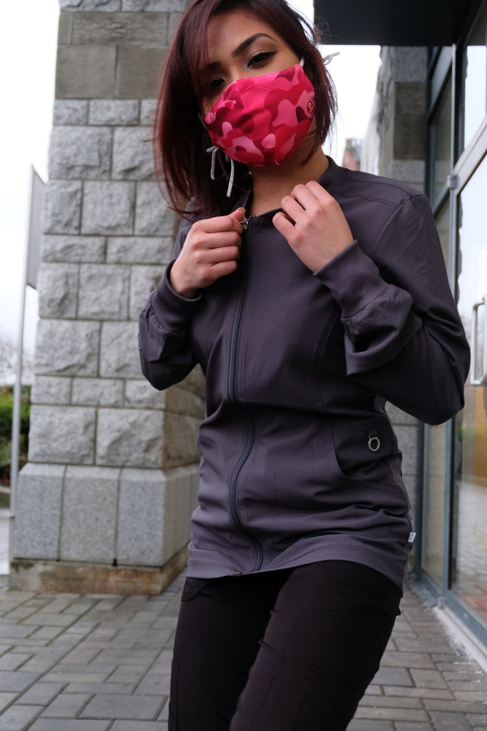 Women's Performance Scrub Jacket in charcoal front view worn with black scrub pants on model