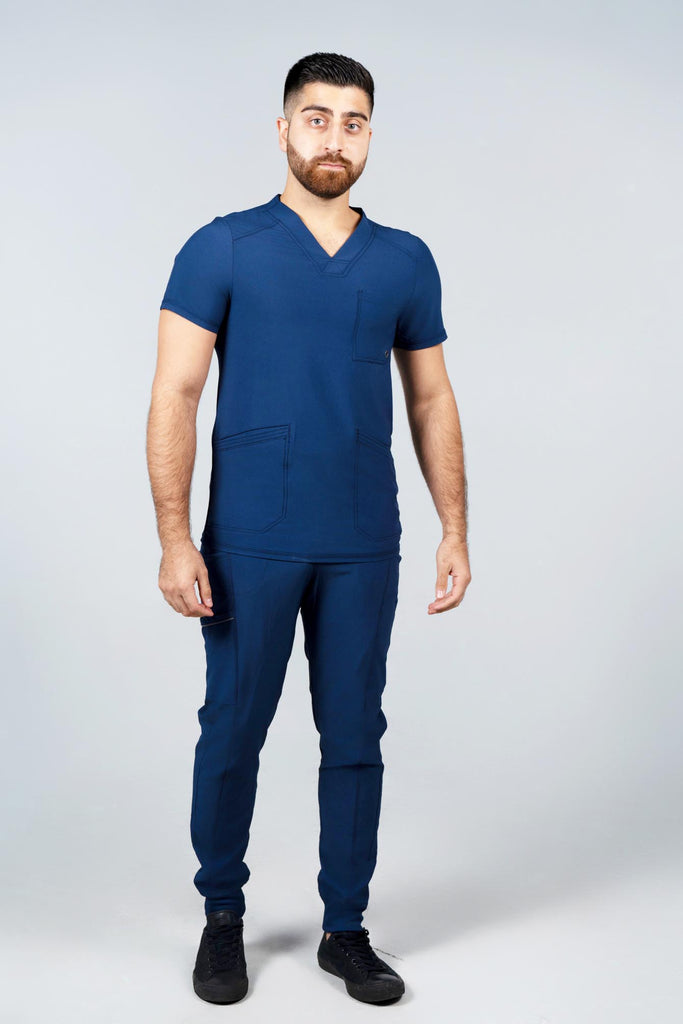 Men's Performance Scrub Top in Navy front view on model wearing matching navy jogger scrub pants