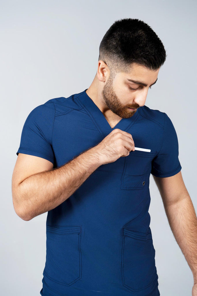 Men's Performance Scrub Top in Navy model reaching into top chest pocket