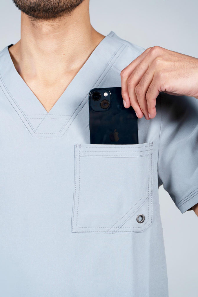 Men's Performance Scrub Top in Light Grey model putting phone into top chest pocket