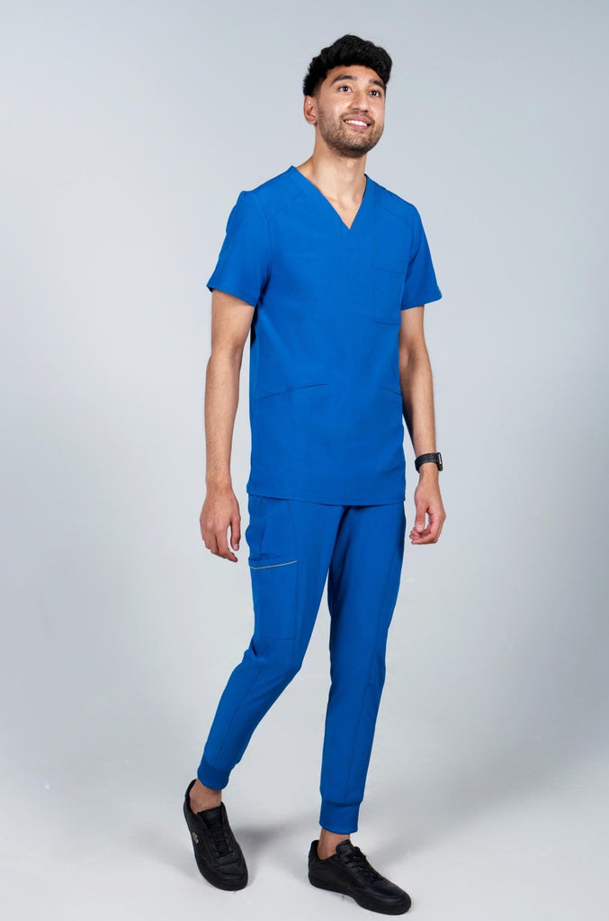 Men's Performance Scrub Top in Royal Blue front view on model wearing matching royal blue jogger scrub pants